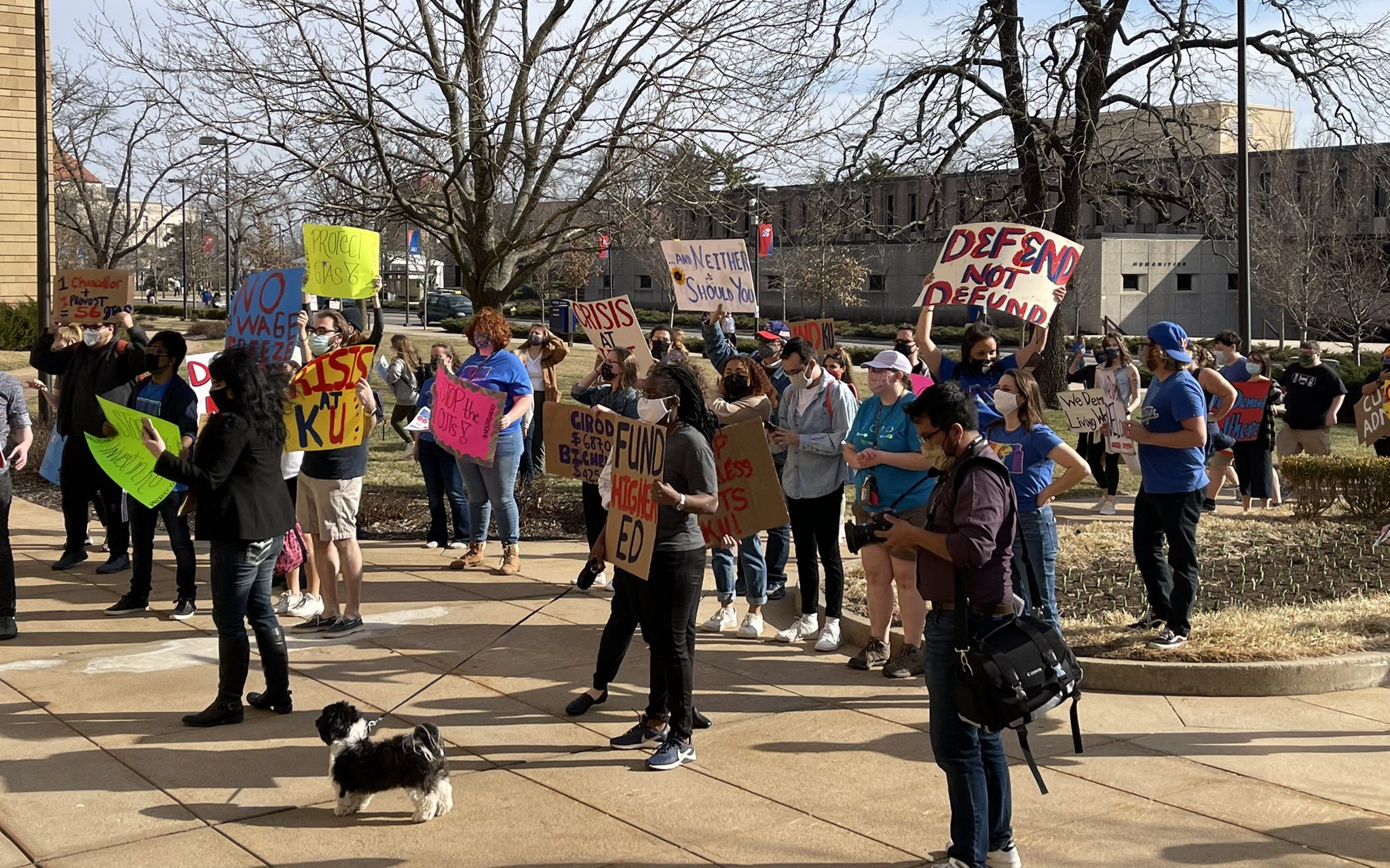 Dozens protest proposed cuts to graduate teaching positions at KU The