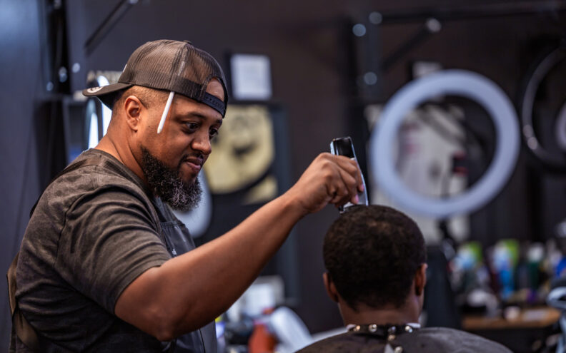 Marty Watson, owner of Watson's Barbershop, cuts a customer's hair at the new shop inside Walmart on Friday, July 19, 2024.